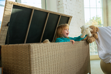 Image showing Little girls in soft warm pajamas playing at home