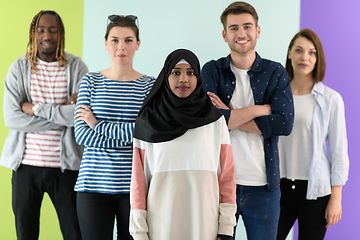 Image showing group of diverse teenagers posing in a studio, determined teenagers in diverse clothing.