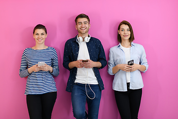 Image showing group of friends have fun and dance while using a cell phone and headphones