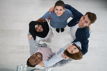 Image showing top view of diverse group of people standing embracing and symbolizing togetherness