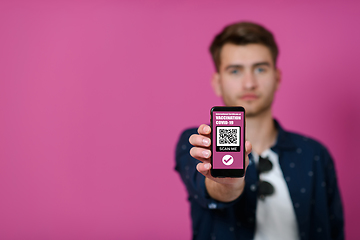 Image showing covid passport a young man shows his qr code and covid19 passport on his cell phone