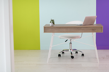 Image showing home office concept. chair, laptop, desk and flowers.