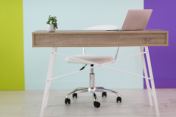 Image showing home office concept. chair, laptop, desk and flowers.