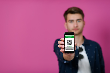 Image showing covid passport a young man shows his qr code and covid19 passport on his cell phone