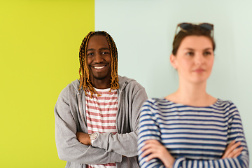 Image showing afro guy and european woman with arms crossed posing in studio