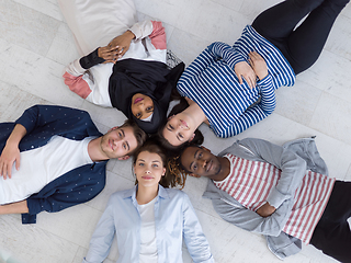 Image showing top view of a diverse group of people lying on the floor and symbolizing togetherness