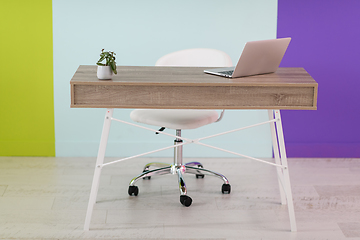 Image showing home office concept. chair, laptop, desk and flowers.