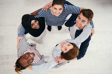 Image showing top view of diverse group of people standing embracing and symbolizing togetherness