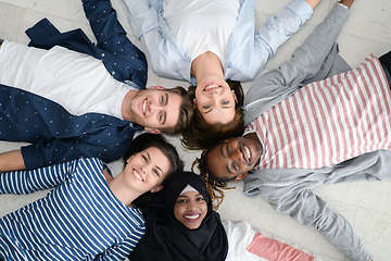 Image showing top view of a diverse group of people lying on the floor and symbolizing togetherness