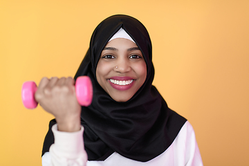 Image showing afro muslim woman promotes a healthy life, holding dumbbells in her hands