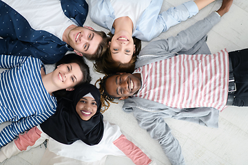 Image showing top view of a diverse group of people lying on the floor and symbolizing togetherness