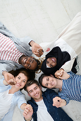 Image showing top view of a diverse group of people lying on the floor and symbolizing togetherness