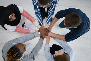 Image showing top view of diverse group of people standing embracing and symbolizing togetherness