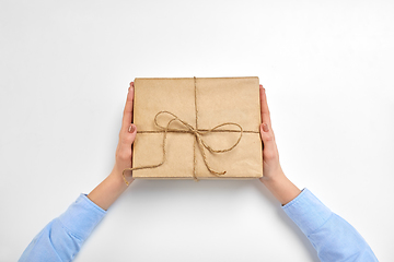 Image showing hands with parcel box tied by rope at post office