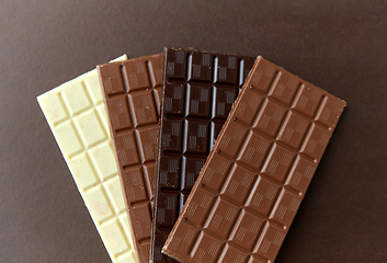 Image showing different kinds of chocolate on brown background