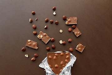 Image showing milk chocolate bar with hazelnuts in foil wrapper