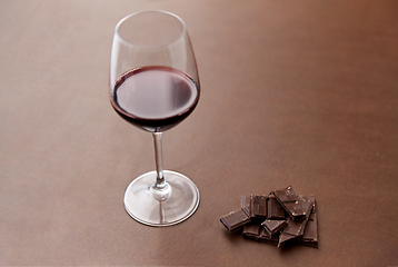 Image showing dark chocolate pieces and glass of red wine