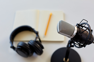 Image showing headphones, microphone and notebook with pencil