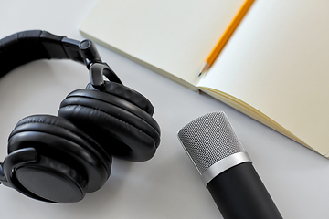 Image showing headphones, microphone and notebook with pencil