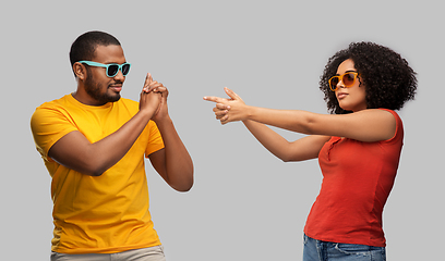 Image showing african couple in sunglasses making gun gesture