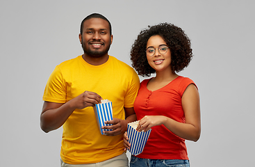 Image showing happy african american couple eating popcorn