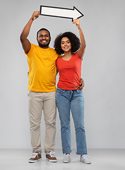 Image showing happy african american couple holding arrow