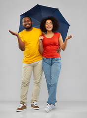 Image showing smiling african american couple with umbrella