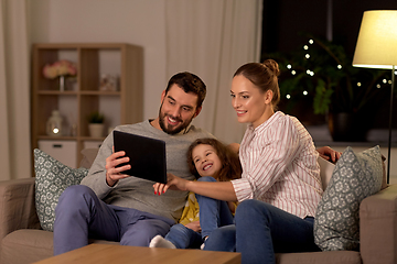 Image showing happy family with tablet computer at home at night