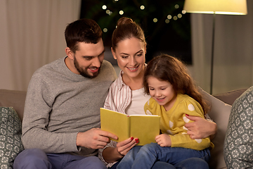 Image showing happy family reading book at home at night