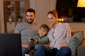 Image showing happy family watching tv at home at night