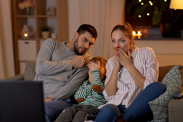 Image showing scared family watching tv at home at night