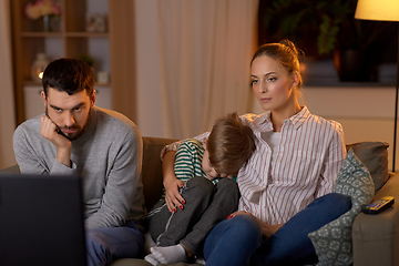 Image showing family watching something boring on tv at night