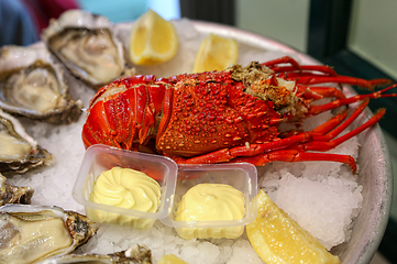Image showing Dish of fresh seafood, lobster with oysters with lemon and sauce