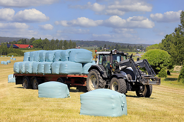 Image showing Tractor Pulling Trailer Full of Silage Bales