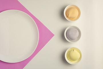 Image showing Multicolored marshmallows in white cups and empty white dish on pink