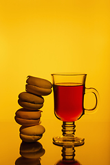 Image showing Strong aromatic tea in cup and marshmallows on a bright background