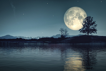 Image showing moon and stars over dark scenery