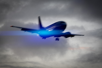 Image showing plane in the sky motion blur with blue light flare