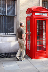 Image showing phone box London with man