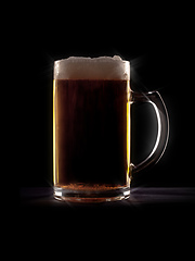 Image showing typical beer in a glass with black background