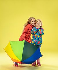 Image showing A full length portrait of a bright fashionable girls in a raincoat