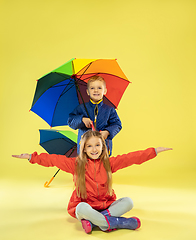 Image showing A full length portrait of a bright fashionable kids in a raincoat