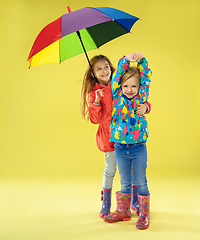 Image showing A full length portrait of a bright fashionable girls in a raincoat