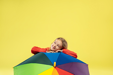 Image showing A full length portrait of a bright fashionable girl in a raincoat