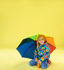 Image showing A full length portrait of a bright fashionable girl in a raincoat