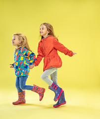 Image showing A full length portrait of a bright fashionable girls in a raincoat