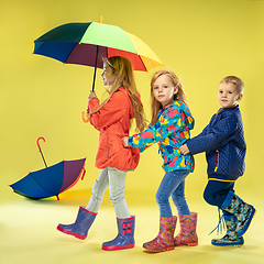 Image showing A full length portrait of a bright fashionable kids in a raincoat