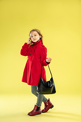 Image showing A full length portrait of a bright fashionable girl in a raincoat