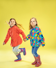 Image showing A full length portrait of a bright fashionable girls in a raincoat