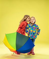 Image showing A full length portrait of a bright fashionable girls in a raincoat